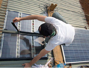 Installing solar panels in Rwanda