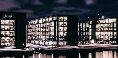 Office buildings at night with the lights on