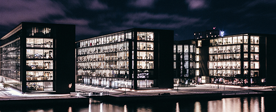Office buildings at night with the lights on