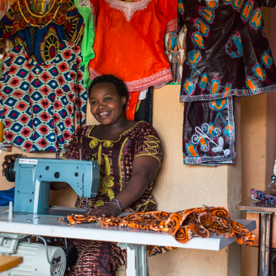 Example of productive use of energy facilitated by MeshPower and E4I, a tailor using an electric sewing machine to create unique designs on dresses. Photo from Meshpower
