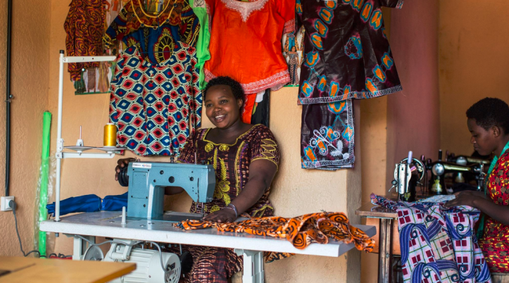 Example of productive use of energy facilitated by MeshPower and E4I, a tailor using an electric sewing machine to create unique designs on dresses. Photo from Meshpower