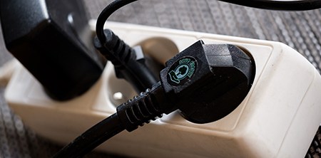 A selection of plugs in power sockets